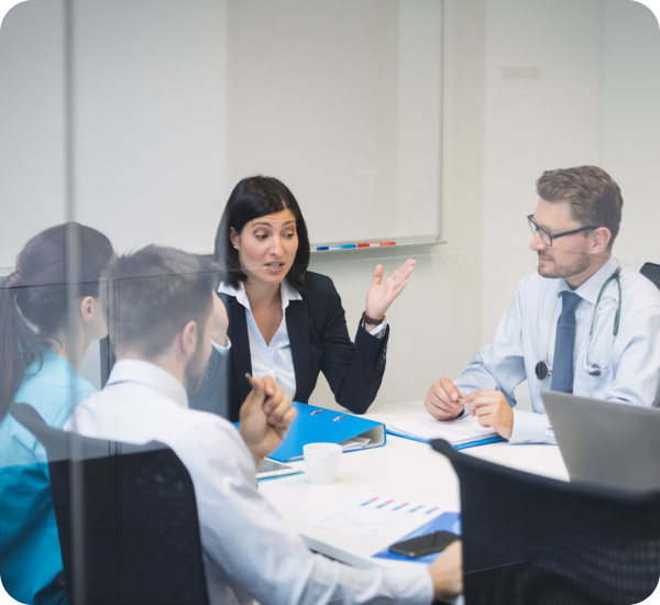 Team meeting with doctor discussing documents