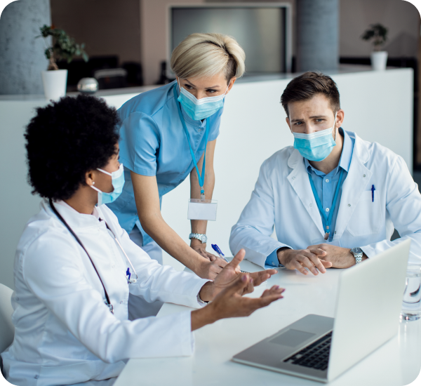 doctors discussing while looking at a laptop